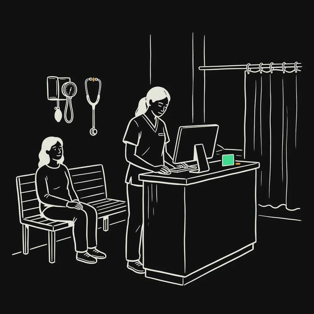 A nurse updating a record at a clinic reception desk while a patient waits calmly nearby.