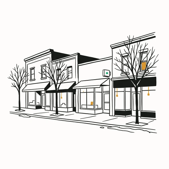 A row of small main-street shopfronts on a winter city street, with bare trees and warm light in the windows.